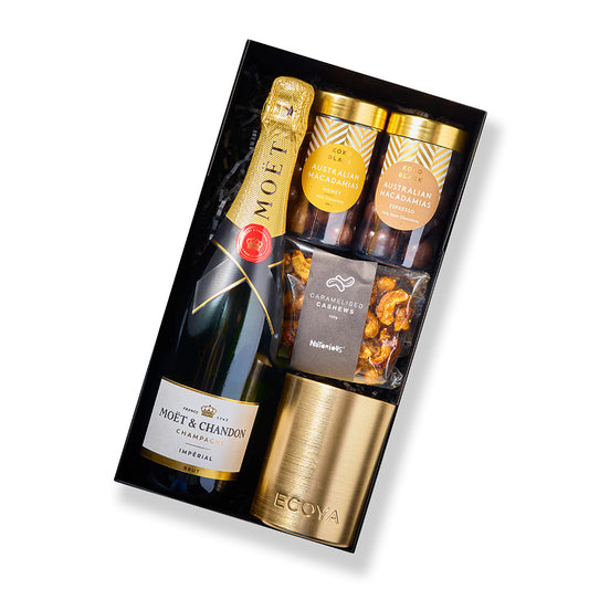 Celebrations hamper with Moët & Chandon Brut, caramelised cashews, Ecoya candle, and Koko Black macadamias.